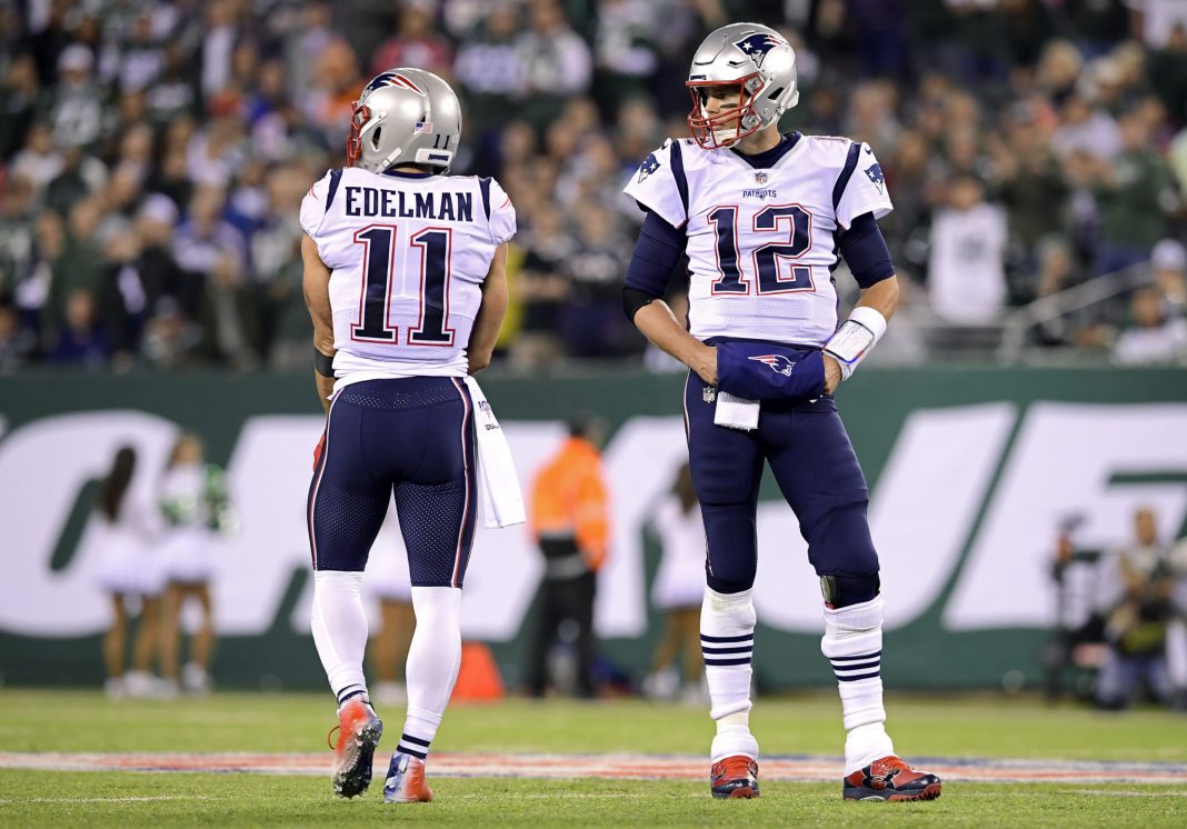 EAST RUTHERFORD, NEW JERSEY - OCTOBER 21: Julian Edelman #11 and Tom Brady #12 of the New England Patriots looks on against the New York Jets at MetLife Stadium on October 21, 2019 in East Rutherford, New Jersey. (Photo by Steven Ryan/Getty Images)